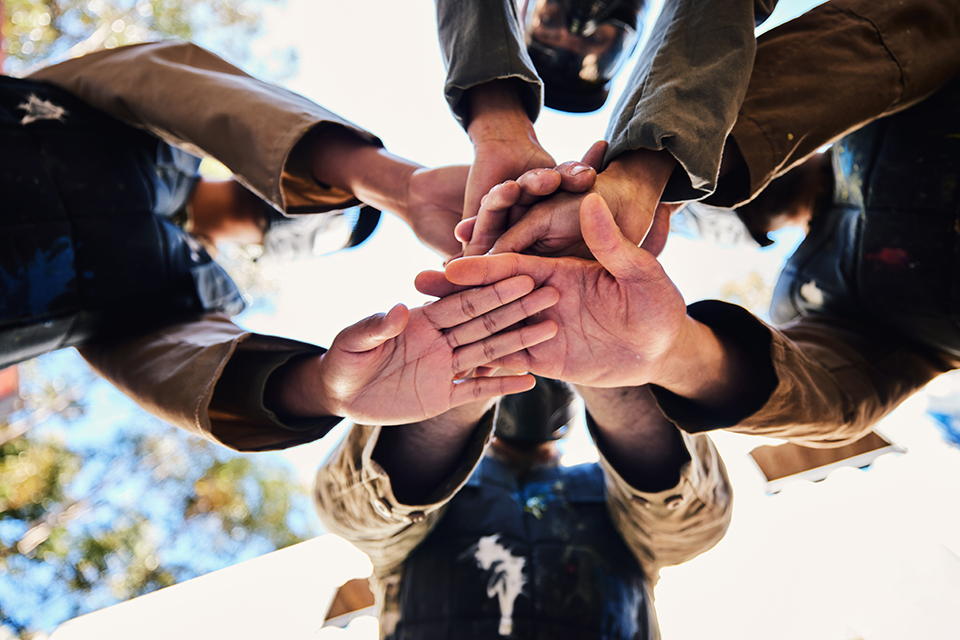 Goals, paintball team or hands in huddle for strategy, hope or soldier training on war battlefield